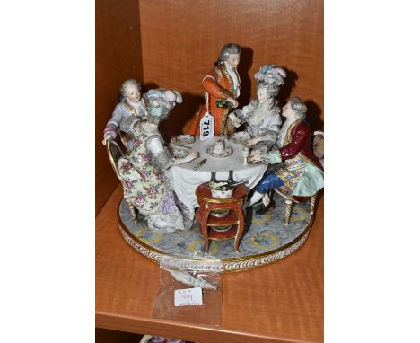 A 19TH CENTURY PARIS PORCELAIN FIGURE GROUP OF FIVE 18TH CENTURY FIGURES AROUND A DINING TABLE, with raised glasses and the t