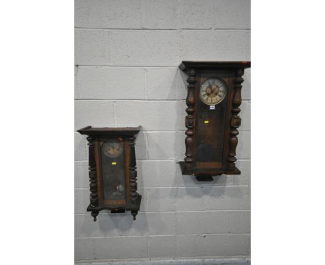 TWO 19TH CENTURY VIENNA WALL CLOCKS, each clock with an arched glass door, that's enclosing an enamel dial, depicting Roman n