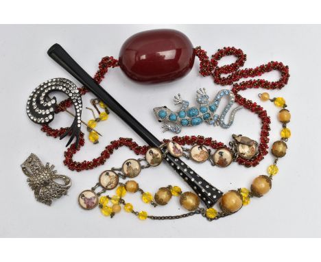 A SMALL BAG OF ITEMS, to include a large oval cherry amber colour Bakelite bead fitted on a red beaded necklace, bead measuri