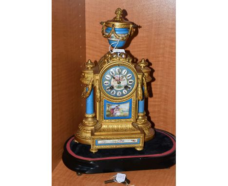 A SECOND HALF 19TH CENTURY GILT METAL AND PORCELAIN MANTEL CLOCK, urn finial, the case with two porcelain columns flanking th