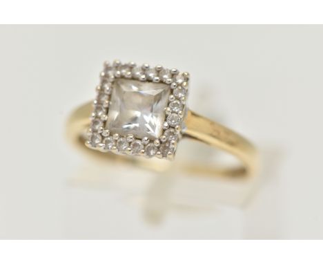 A 14CT GOLD GEM SET RING, the square shape colourless gem within a circular gem surround, gems assessed as quartz, 14ct hallm