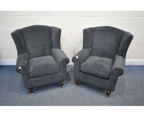 A PAIR OF DARK BLUE UPHOLSTERED ARMCHAIRS, along with a brown footstool (condition report: in need of a light clean, one loos
