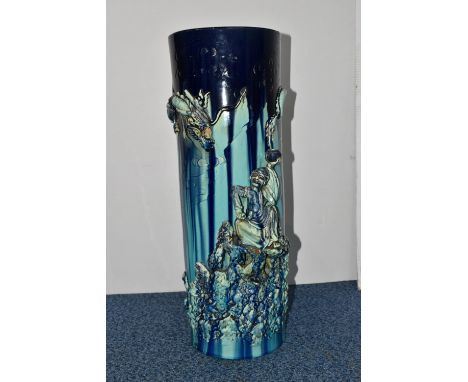 A LATE 19TH CENTURY JAPANESE POTTERY STICK STAND OF CYLINDRICAL FORM WITH RELIEF DECORATION IN THE FORM OF A DRAGON AND AN EL