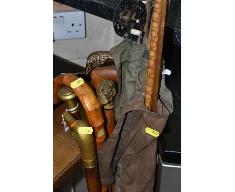 THREE SPLIT CANE FISHING RODS AND A COLLECTION OF WALKING STICKS, three vintage fishing rods with cork handles, one with reel