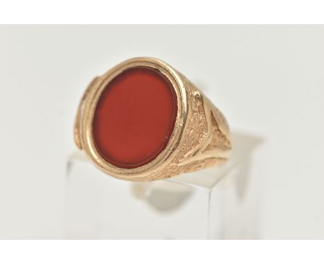 A 9CT GOLD SIGNET RING, designed as an oval carnelian panel within a tapered ring mount with textured detail, 9ct hallmark ru