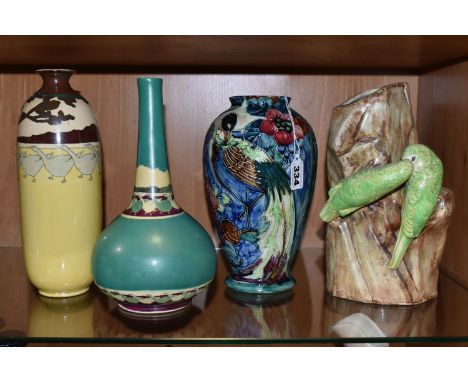 A GROUP OF FOUR VASES, comprising a Thomas Forrester Trogon Ware vase tube lined with an exotic bird amongst flowers and foli