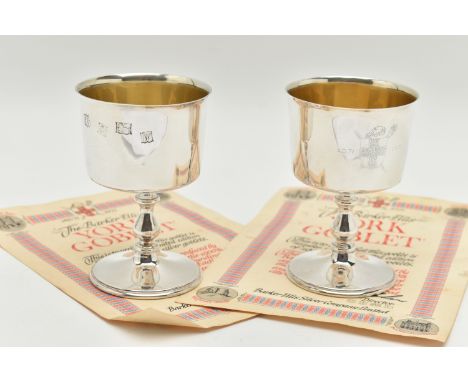 A PAIR OF ELIZABETH II SILVER GOBLETS, polished cups engraved with a family crest inscribed 'A.D.71 1971', gilt interiors, wi
