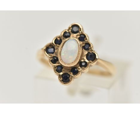 A 9CT GOLD OPAL AND SAPPHIRE RING, designed as a central oval opal cabochon within a circular sapphire surround, 9ct hallmark