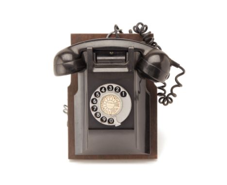 A WALL MOUNTED BAKELITE TELEPHONE
With a rotary dial
15 x 19 x 26.5 cm
Condition: Minor signs of wear commensurate with age a