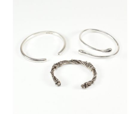 A group of three 925 silver bangle bracelets. The lot to include a twisted &amp; granulated design cuff bangle of arts &amp; 