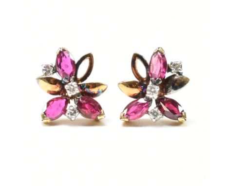 A pair of gold ruby and diamond earrings. The earrings in flower form set with round brilliant cut diamonds and marquise cut 