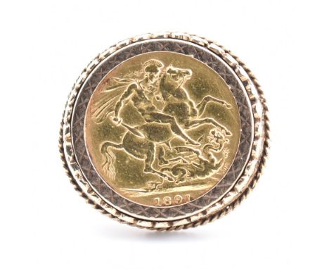 A Victorian 1891 sovereign in hallmarked 9ct gold ring mount. The ring set with an 1891 full sovereign coin with St. George o