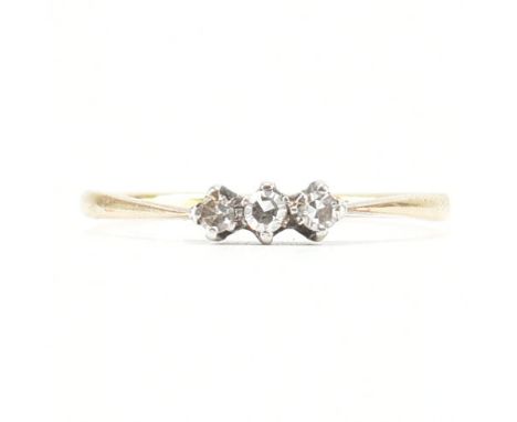 An antique 18ct yellow gold, platinum &amp; diamond three stone ring. The ring having three round cut diamonds to pinched sho