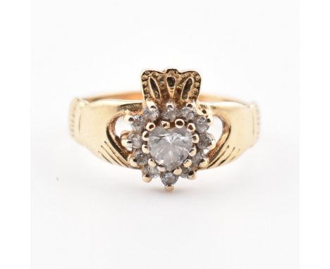 A hallmarked 9ct yellow gold &amp; cubic zirconia Claddagh ring. The ring of classic design having two etched hands clasping 