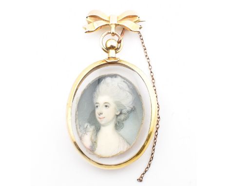 A hallmarked 9ct yellow gold portrait locket brooch pin. The antique locket pendant brooch having a central portrait of a lad