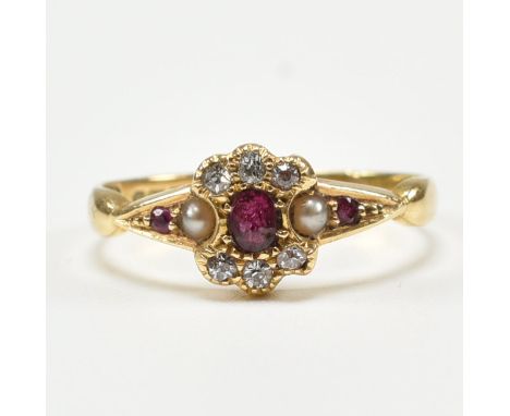 An antique hallmarked 18ct yellow gold, ruby, diamond &amp; pearl ring. The ring having a central oval cut ruby surrounded by