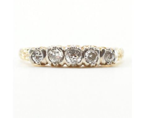 A gold and diamond five stone ring. The ring set with five old cut diamonds having a pierced and scrolled gallery shoulders t