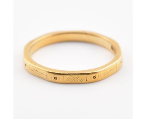 A hallmarked 22ct yellow gold band ring. The ring of octagonal form having etched decoration throughout. Hallmarked for Birmi