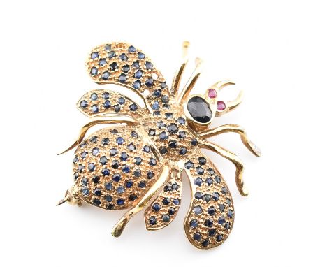 A vintage yellow metal, sapphire &amp; ruby brooch pin. The AF brooch in the form of a flying insect having an oval cut bezel