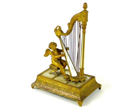 A French Palais Royale ormolu jewel stand incorporating a music box, early 19th century, in the form of a cherub, seated on a