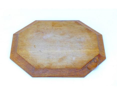 A Robert 'Mouseman' Thompson carved oak breadboard, of octagonal form with carved mouse signature, 30.5 by 25 by 2cm high. 