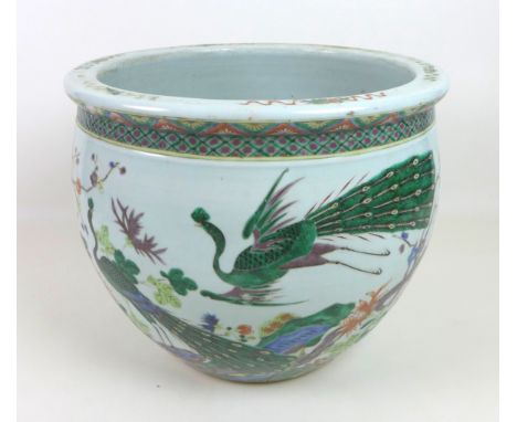 A Chinese porcelain Famille Verte fish bowl, decorated in Kangxi style with two peacocks amongst trees, flowers and foliage, 
