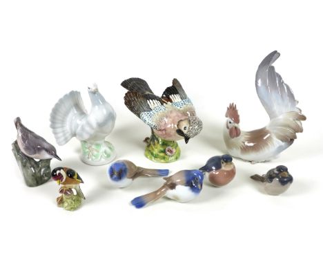 A group of nine ceramic figurines, all modelled as birds, comprising a Beswick 'Jay', model 1219, impressed marks, a/f chip t