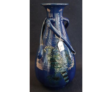 C.H Brannam Pottery three handled baluster vase with flared neck decorated with a stylised parrot on branch with foliage. Hei