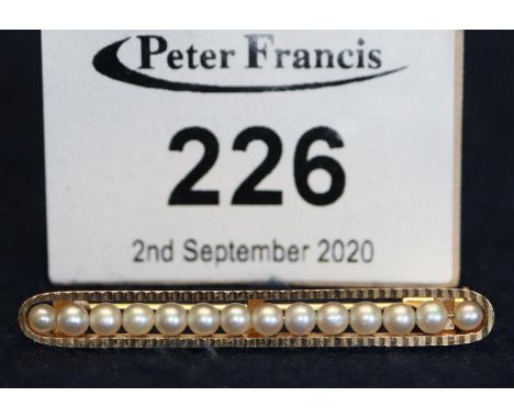 Yellow metal and seed pearl bar brooch pin, tests as 18ct. (B.P. 21% + VAT) 