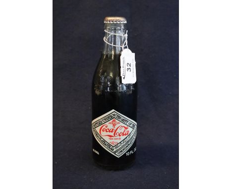 A 75th Anniversary 1907-1982 unopened bottle of Coca-Cola. 10 fluid ozs with vintage labelling and moulding. (B.P. 21% + VAT)