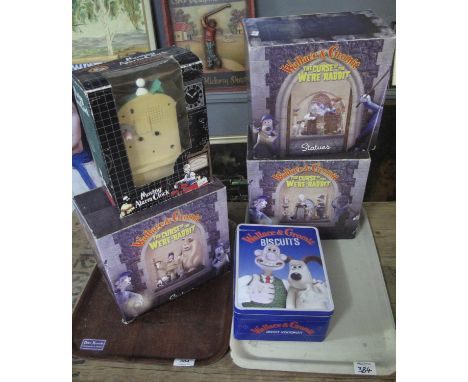 A collection of Wallace and Gromit items, all in original boxes to include; moving alarm clock, biscuit tin, 'The Curse of th