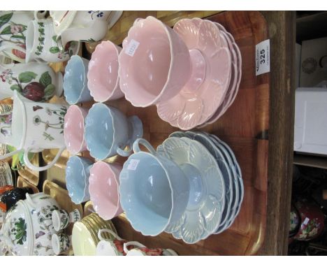 A tray of unmarked blue and pink cups and saucers decorated with moulded petals. (B.P. 21% + VAT) 