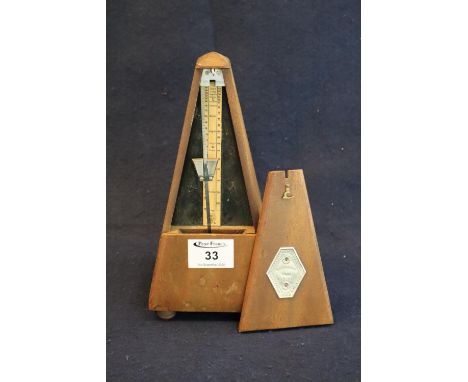 Conically mahogany metronome by Maelzel of Paris. 22cm high aprpox. (B.P. 21% + VAT) Rather dry overall but no obvious damage