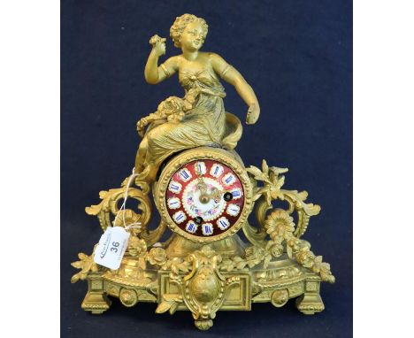 19th Century French gilded spelter figural mantel clock with painted ceramic face and brass drum movement. 31cm high approx. 