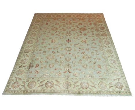 JAIPUR CARPET, scrolling vines and palmettes on a duck egg blue ground with a corresponding ivory border, 305cm x 239cm.