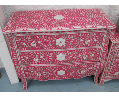 BOMBE COMMODE, Indian design with three drawers and pink ground with mother of pearl inlay, 91cm x 41cm x 76cm H. (with fault