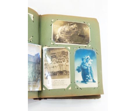 Postcard album and contents including comical, topographical and portrait postcards, portraits of naval officers, bishops, sc