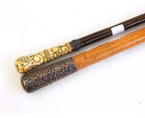 Two canes, one with a silver handle, the other 19th century with pique work inlaid into ivory or bone (2) 