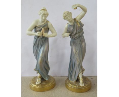 A pair of Royal Worcester James Hadley figures, decorated in shot silk colours of two woman playing instruments, model number