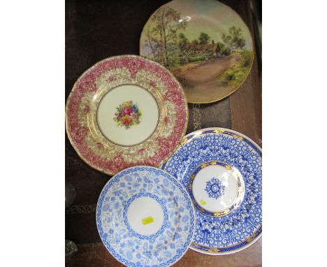 A Royal Worcester plate, decorated with flowers by Hunt, together with a Royal Worcester plate decorated with a view of Anne 