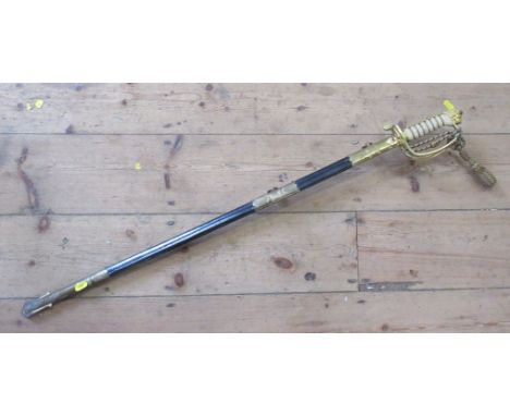 A Wilkinson Sword Co Ltd Naval dress sword, with leather and brass scabbard, etched blade number 70586, with gilt metal and s