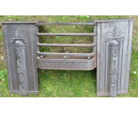 A cast iron fire grate , with neo classical decoration