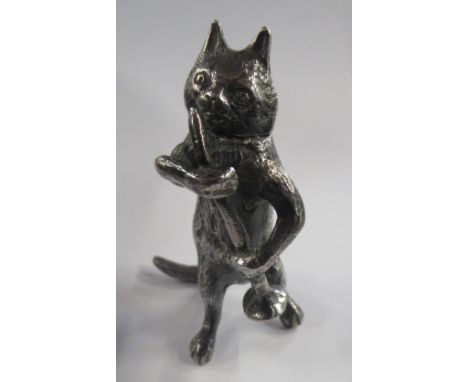 A novelty miniature silver model, of a cat holing a pipe, the cat with hinged head, af, height 2ins