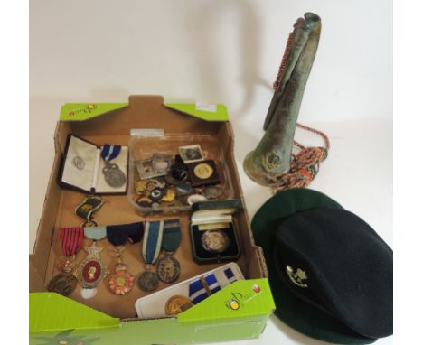 A Special Service Group copper bugle; two green berets; various replica medals; medallions, whistle and other similar items