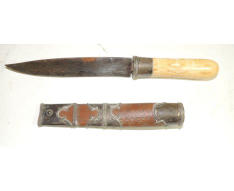 A Burmese dha dagger having plain ivory grip, white metal mount, tapering single edge blade and in wood scabbard with white m