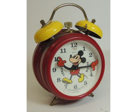 A Bradley (German made)  Mickey Mouse alarm clock in red plastic case with yellow painted metal bells, the dial with image of