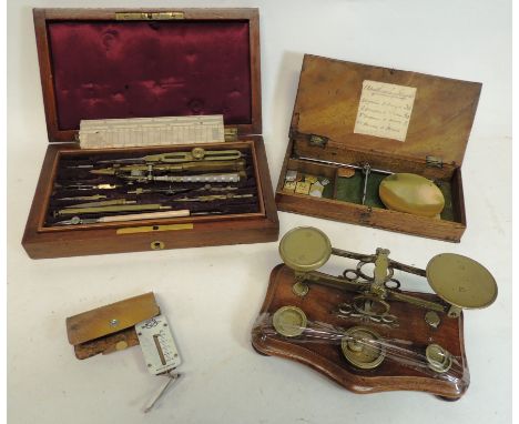 A set of domestic postal scales and brass weights on mahogany base; drawing instruments in polished mahogany case; apothecary