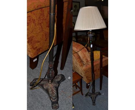 A modern metal effect standard lamp, the reeded column raised on a tri footed base, 113cm high, with a cream silk pleated sha