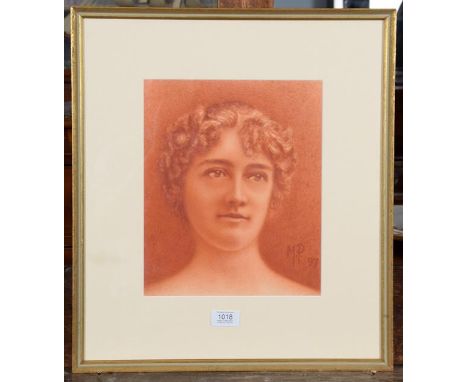 A pastel portrait of a young lady, monogrammed M P 1897, 29cm by 24cm