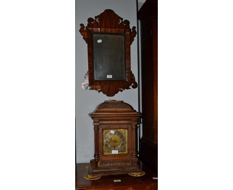 A German quarter chiming walnut cased table clock, 32cm by 21cm by 45cm; together with a mahogany fret work mirror, 65cm by 4